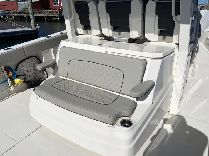  Yacht Photos Pics 2022 Pursuit 378S boat seating area with gray cushioned seats and armrests.
