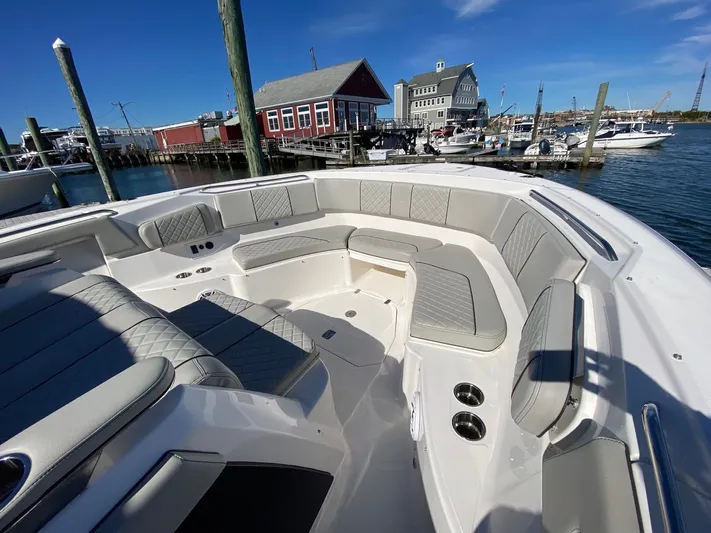  Yacht Photos Pics Luxurious 2022 Pursuit 378S boat interior with spacious seating at a scenic marina.