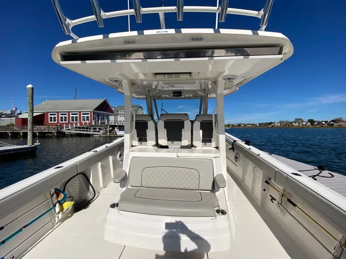  Yacht Photos Pics 2022 Pursuit 378S boat docked at marina, clear blue sky, waterfront view.