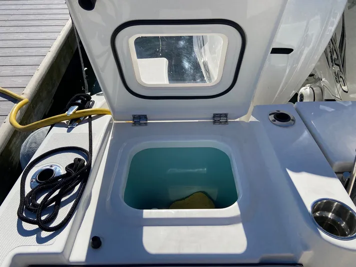  Yacht Photos Pics Open storage compartment on a 2022 Pursuit 378S boat, dockside view.