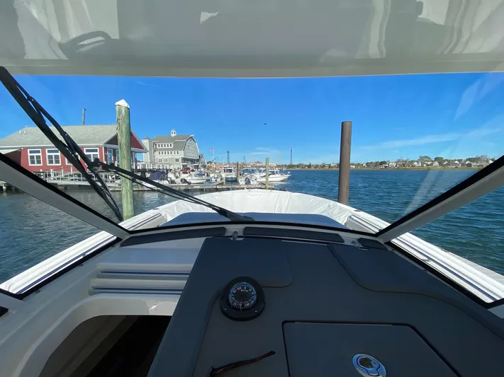  Yacht Photos Pics View from 2022 Pursuit 378S boat cockpit, overlooking marina and waterfront buildings.