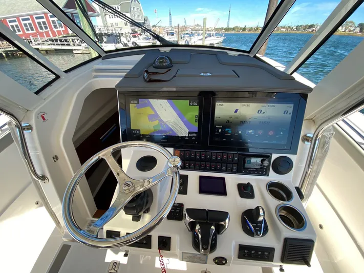 Yacht Photos Pics Helm of 2022 Pursuit 378S boat with advanced navigation and control systems.