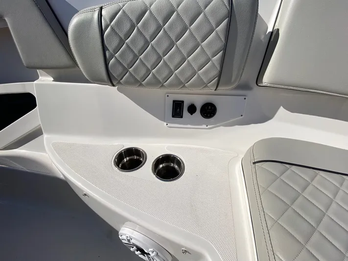  Yacht Photos Pics 2022 Pursuit 378S boat interior with quilted seats and cup holders.