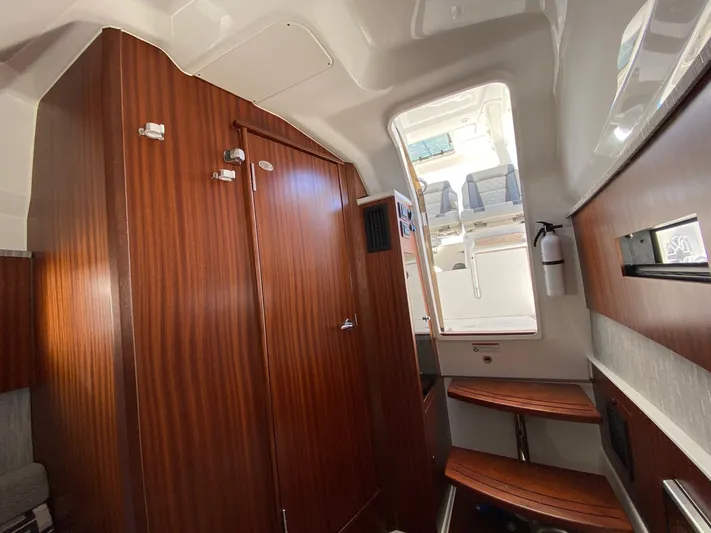  Yacht Photos Pics 2022 Pursuit 378S cabin interior with wooden finishes and seating area.