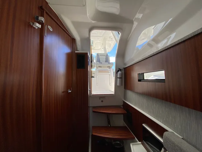  Yacht Photos Pics Interior of 2022 Pursuit 378S boat with wooden finishes and modern design.