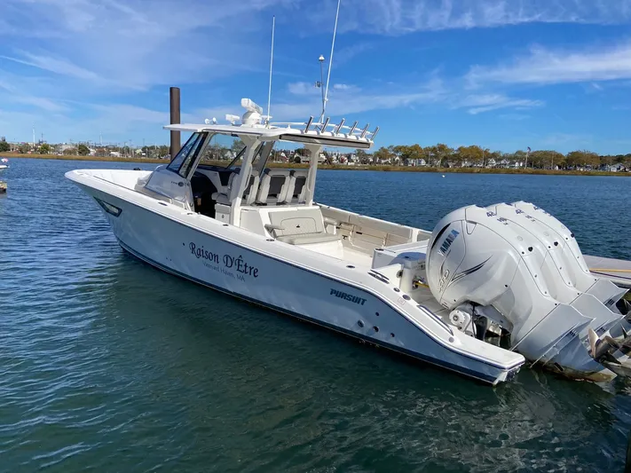 Yacht Photos Pics 2022 Pursuit 378S boat docked on calm water with triple Yamaha engines.