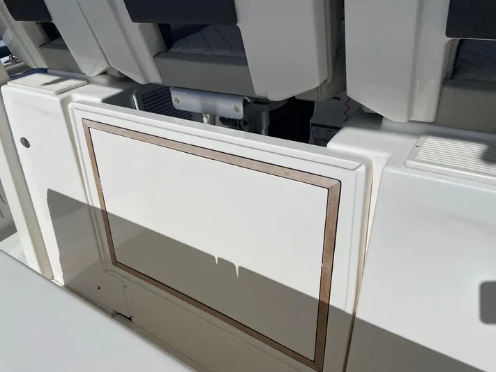  Yacht Photos Pics 2022 Pursuit 378S boat interior detail with storage compartment and seating.