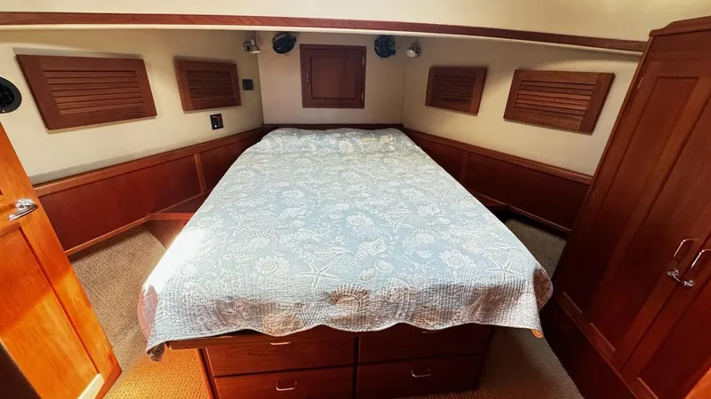 Leto Yacht Photos Pics Cozy cabin interior of 2001 American Tug 34 with a neatly made bed.