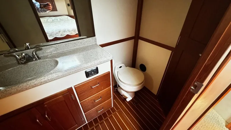 Leto Yacht Photos Pics Bathroom interior of a 2001 American Tug 34, featuring a sink and toilet.