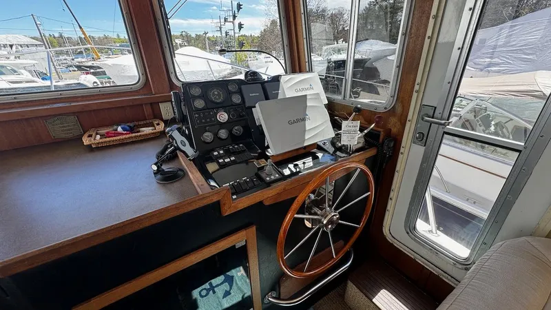 Leto Yacht Photos Pics Pilot house of a 2001 American Tug 34 with navigation equipment and steering wheel.