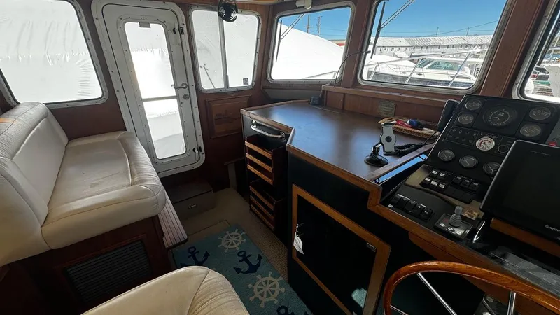 Leto Yacht Photos Pics Interior of a 2001 American Tug 34, featuring helm and seating area.