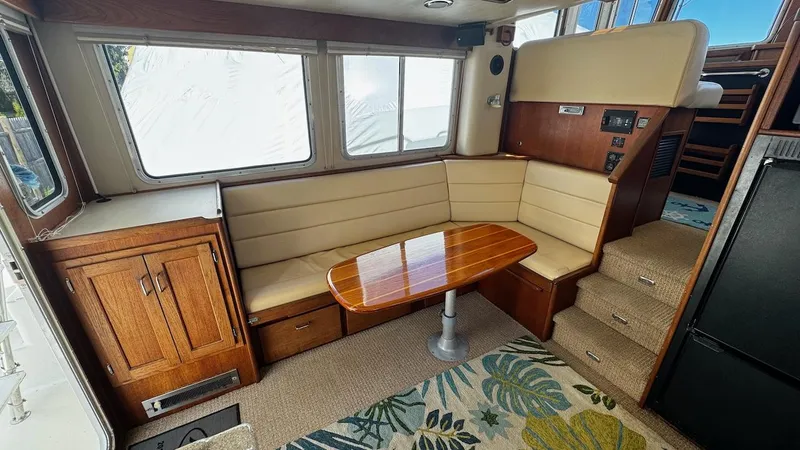 Leto Yacht Photos Pics Interior of 2001 American Tug 34 with cozy seating and wooden table.