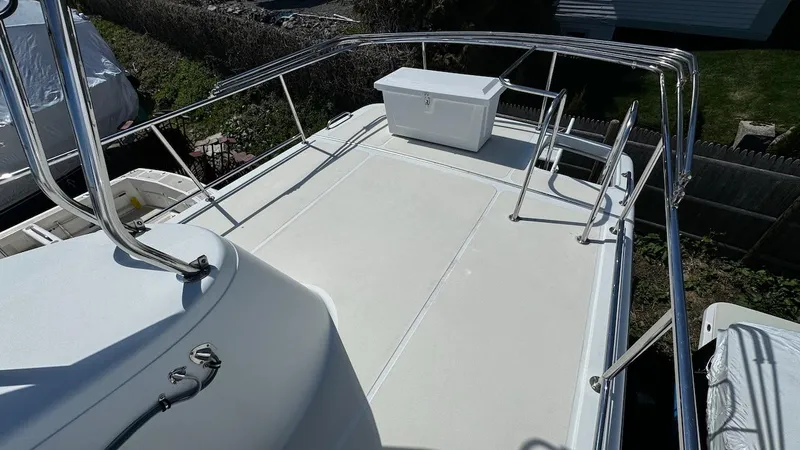 Leto Yacht Photos Pics Rooftop deck of 2001 American Tug 34 with railing and storage box.