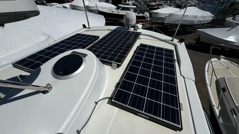 Leto Yacht Photos Pics Solar panels on 2001 American Tug 34 boat deck in marina.