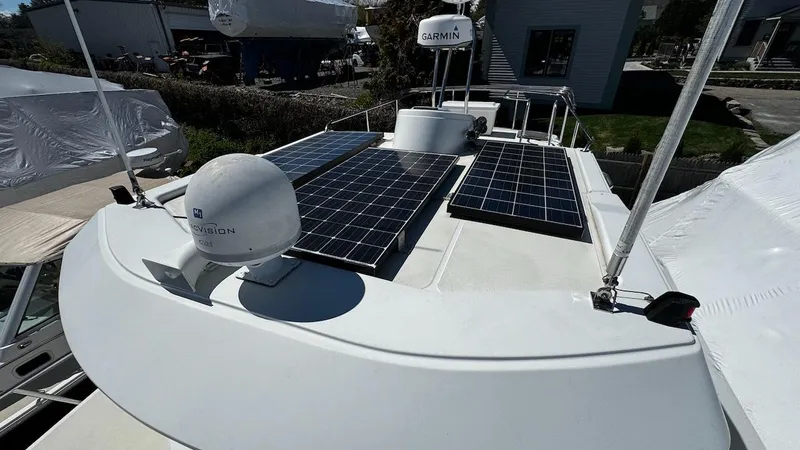 Leto Yacht Photos Pics Rooftop solar panels on a 2001 American Tug 34 boat, featuring navigation equipment.