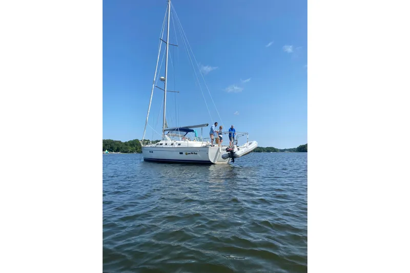  Yacht Photos Pics 2003 Beneteau Oceanis 42CC sailboat on calm water with people onboard.