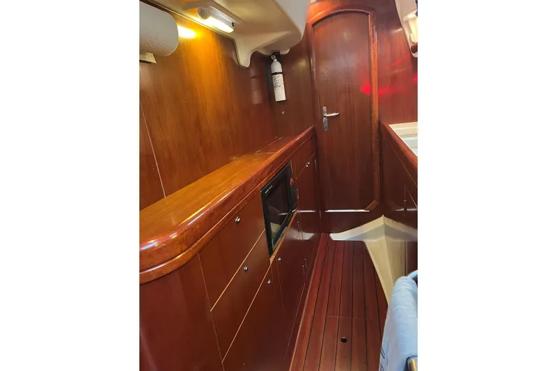  Yacht Photos Pics Interior of 2003 Beneteau Oceanis 42CC yacht with wooden cabinetry and flooring.