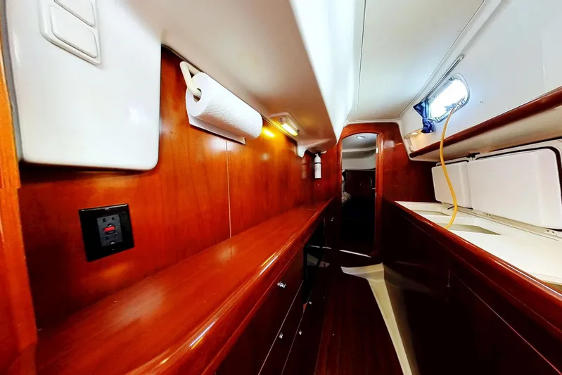 Sea No Evil Yacht Photos Pics Interior of 2003 Beneteau Oceanis 42CC yacht with wooden cabinetry and modern amenities.