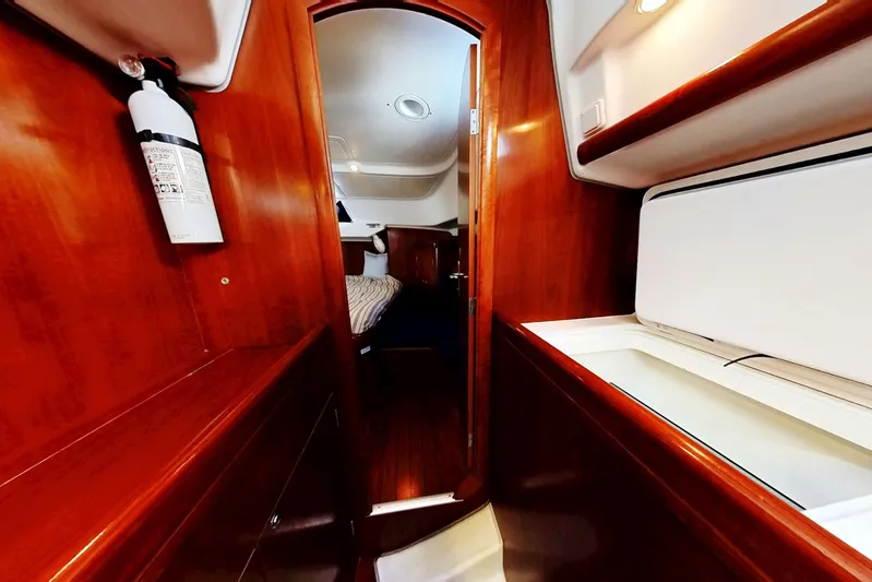 Sea No Evil Yacht Photos Pics Interior of 2003 Beneteau Oceanis 42CC yacht, featuring wood paneling and cozy cabin space.