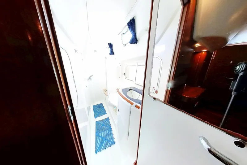 Sea No Evil Yacht Photos Pics Interior of 2003 Beneteau Oceanis 42CC yacht, featuring a bright bathroom with blue mats.