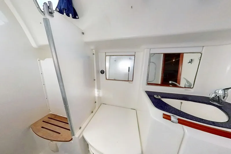 Sea No Evil Yacht Photos Pics Bathroom interior of 2003 Beneteau Oceanis 42CC yacht with shower and sink.
