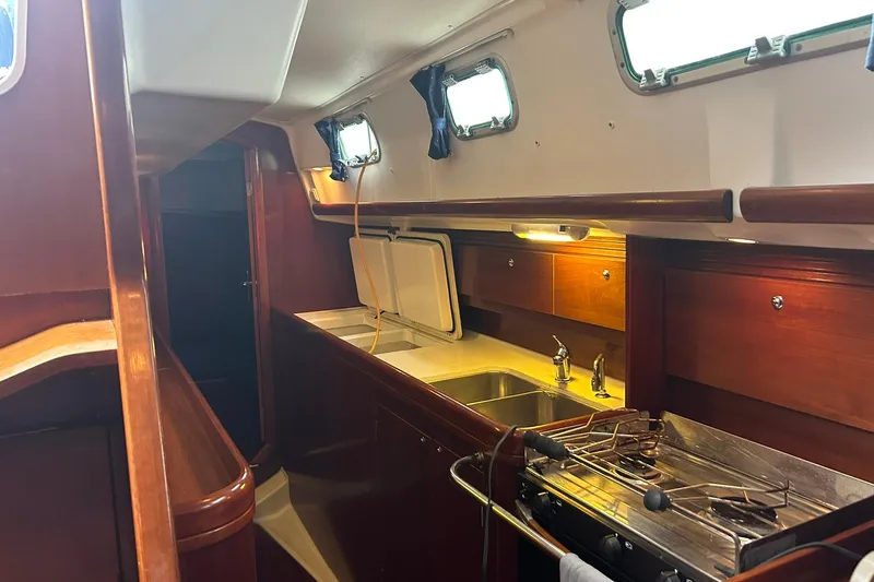 Sea No Evil Yacht Photos Pics Interior of 2003 Beneteau Oceanis 42CC yacht, featuring a well-equipped kitchen area.