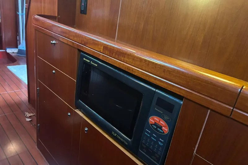 Sea No Evil Yacht Photos Pics Wooden interior of 2003 Beneteau Oceanis 42CC yacht with built-in microwave.