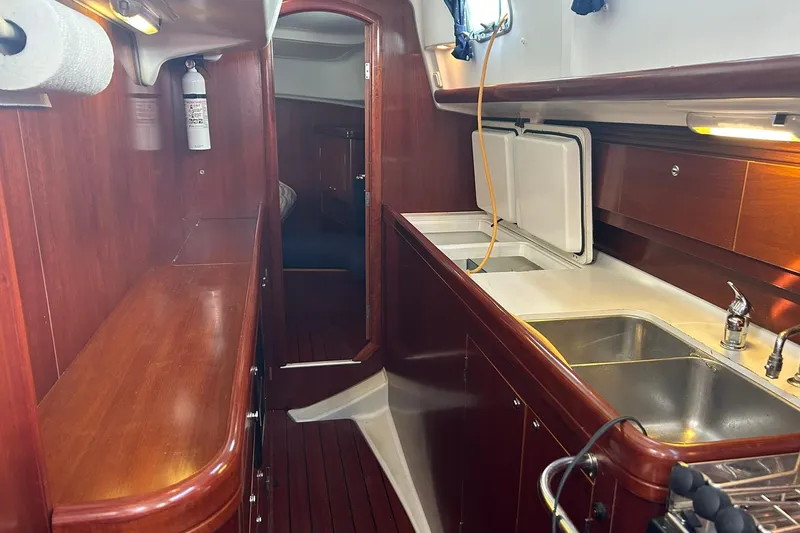 Sea No Evil Yacht Photos Pics Interior of 2003 Beneteau Oceanis 42CC yacht with wooden cabinetry and kitchen sink.
