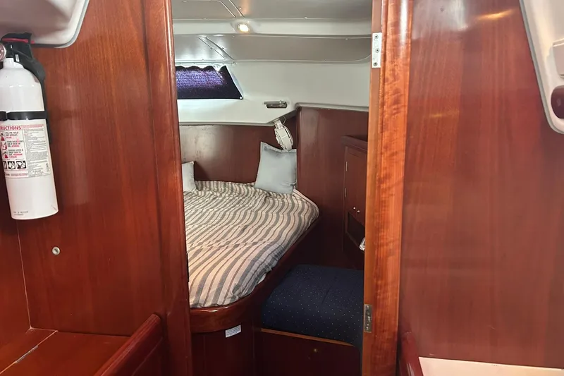 Sea No Evil Yacht Photos Pics Cozy cabin interior of 2003 Beneteau Oceanis 42CC sailboat with wooden finish.
