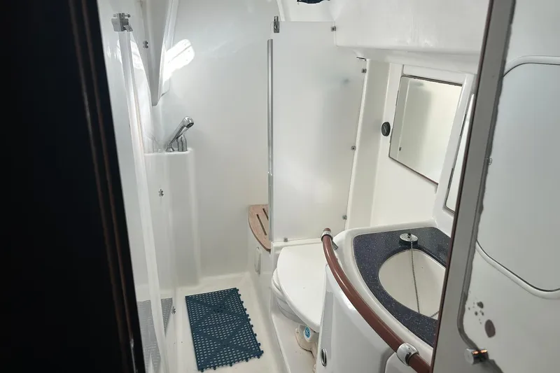 Sea No Evil Yacht Photos Pics Bathroom interior of 2003 Beneteau Oceanis 42CC yacht, featuring shower and sink.