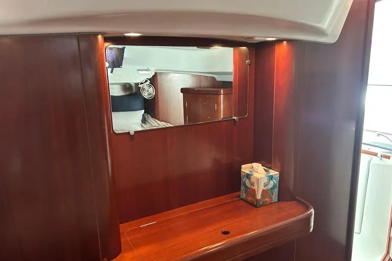 Sea No Evil Yacht Photos Pics Interior of 2003 Beneteau Oceanis 42CC yacht with wooden cabinetry and mirror.
