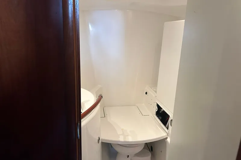 Sea No Evil Yacht Photos Pics Bathroom interior of 2003 Beneteau Oceanis 42CC sailboat, featuring compact design and white fixtures.