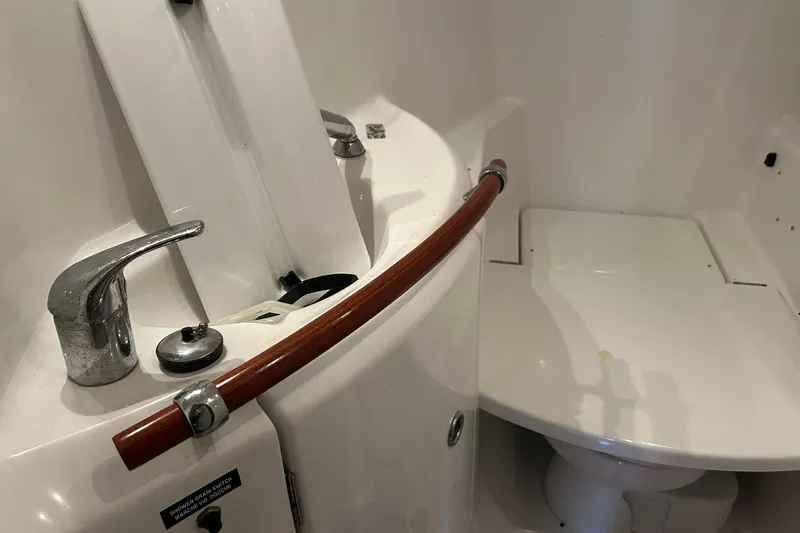 Sea No Evil Yacht Photos Pics Bathroom interior of 2003 Beneteau Oceanis 42CC yacht, featuring sink and faucet.