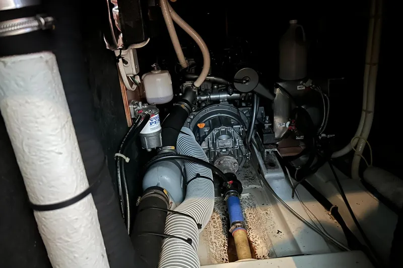 Sea No Evil Yacht Photos Pics Engine room of 2003 Beneteau Oceanis 42CC sailboat, showcasing mechanical components and hoses.