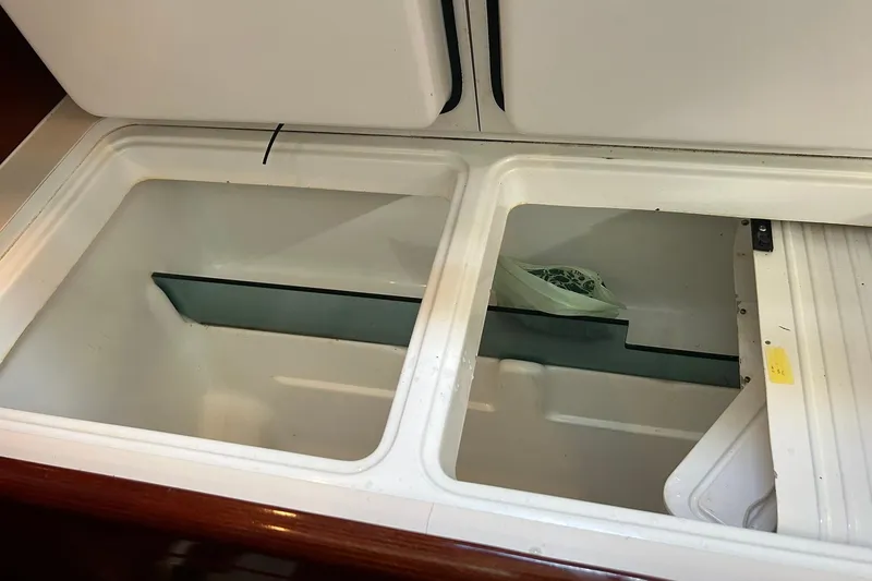 Sea No Evil Yacht Photos Pics Open storage compartment in 2003 Beneteau Oceanis 42CC sailboat interior.