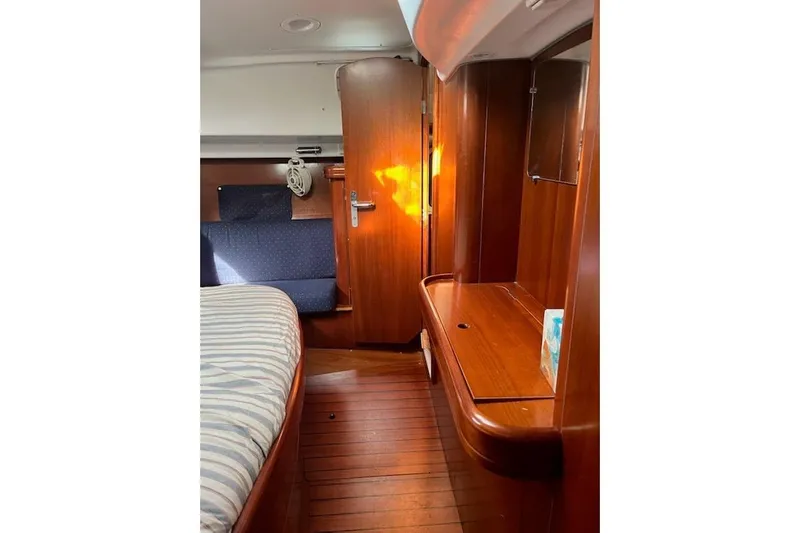 Sea No Evil Yacht Photos Pics Interior of 2003 Beneteau Oceanis 42CC yacht with wooden furnishings and cozy seating.