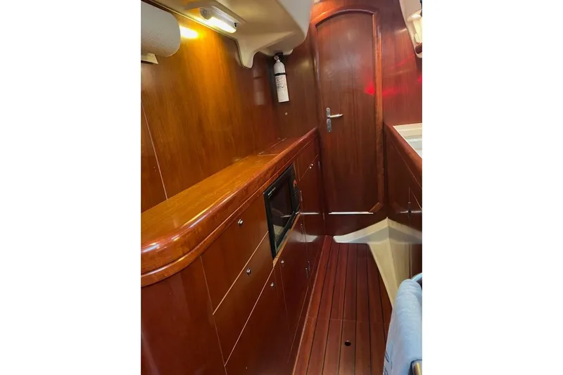 Sea No Evil Yacht Photos Pics Interior of 2003 Beneteau Oceanis 42CC yacht with wooden cabinetry and flooring.