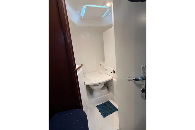Sea No Evil Yacht Photos Pics Bathroom interior of 2003 Beneteau Oceanis 42CC yacht, featuring a compact toilet.