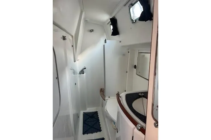 Sea No Evil Yacht Photos Pics 2003 Beneteau Oceanis 42CC yacht bathroom with shower, sink, and porthole window.