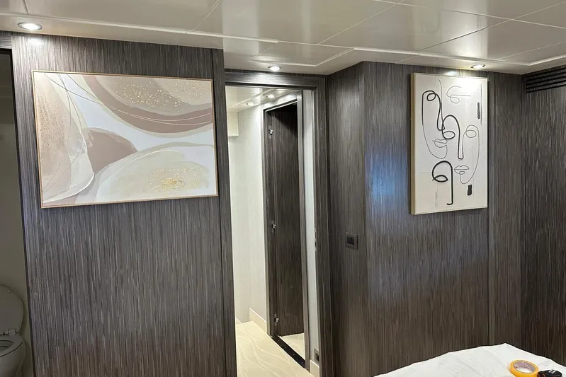  Yacht Photos Pics Luxurious interior of 2021 Terranova Yachts T85 with modern artwork and elegant wood paneling.