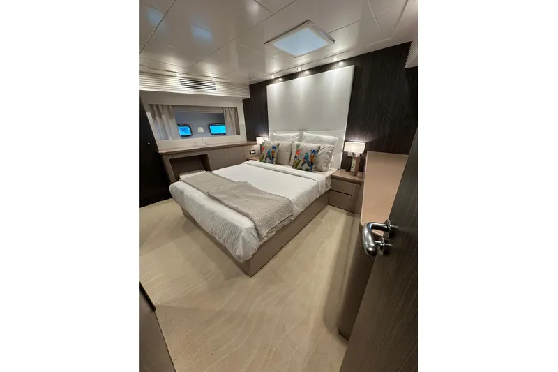  Yacht Photos Pics Luxurious bedroom interior of 2021 Terranova Yachts T85, featuring elegant decor and modern amenities.