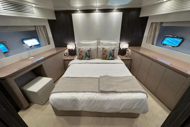  Yacht Photos Pics Luxurious bedroom interior of 2021 Terranova Yachts T85, featuring elegant design and cozy bedding.