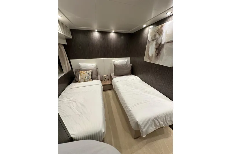  Yacht Photos Pics Luxurious twin bedroom in 2021 Terranova Yachts T85, featuring modern decor and ambient lighting.