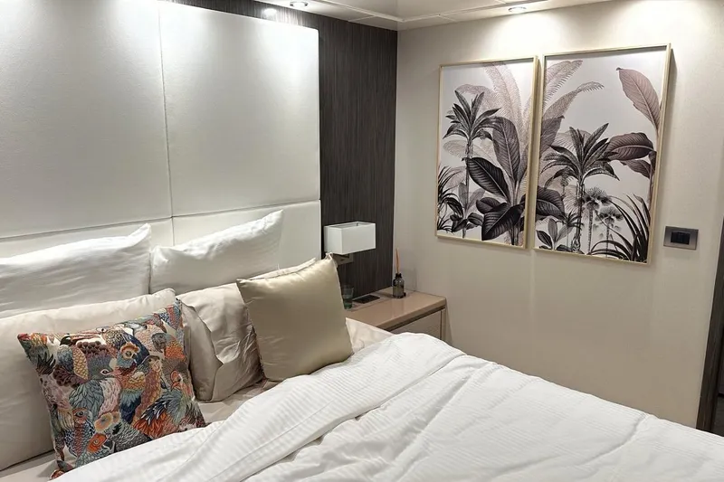  Yacht Photos Pics Luxurious bedroom interior on 2021 Terranova Yachts T85, featuring elegant decor and artwork.