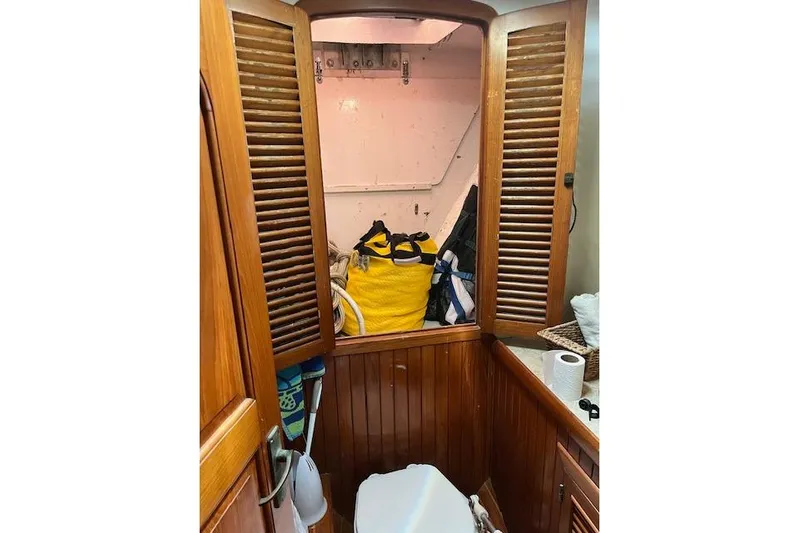 Wind Star Yacht Photos Pics 1986 Liberty 49 boat interior with wooden cabinets and storage area.