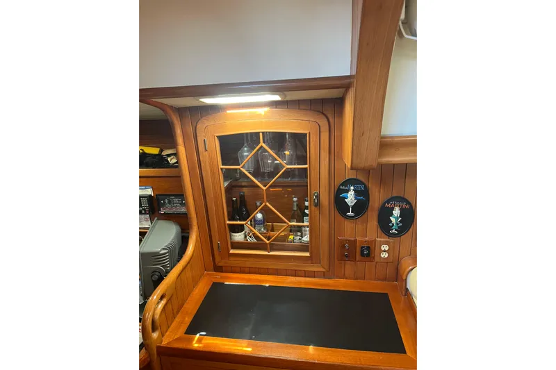 Wind Star Yacht Photos Pics 1986 Liberty 49 yacht interior with wooden cabinetry and decorative elements.