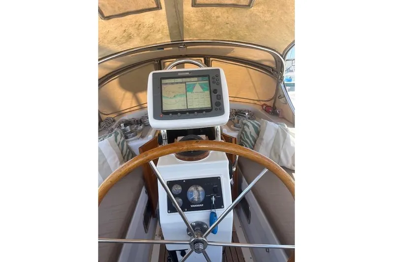 Wind Star Yacht Photos Pics 1986 Liberty 49 yacht helm with navigation system and wooden steering wheel.