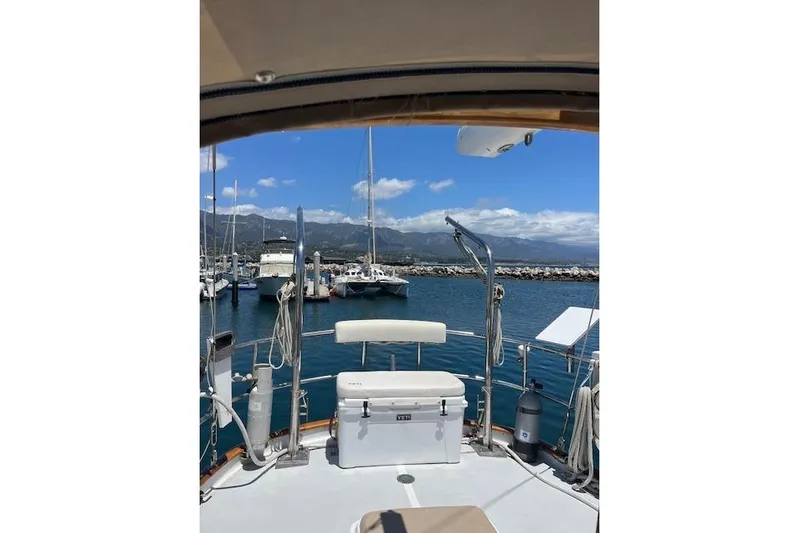 Wind Star Yacht Photos Pics 1986 Liberty 49 yacht docked in a marina with scenic mountain views.