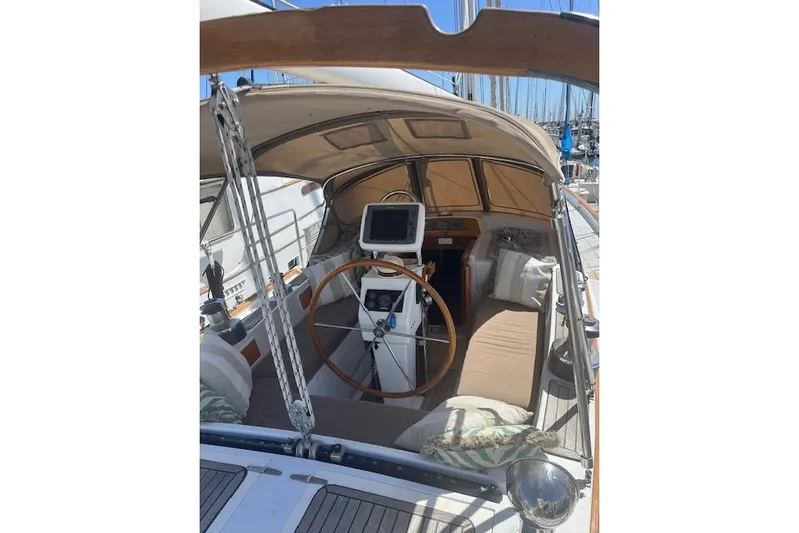 Wind Star Yacht Photos Pics 1986 Liberty 49 sailboat cockpit with wooden wheel and navigation equipment.