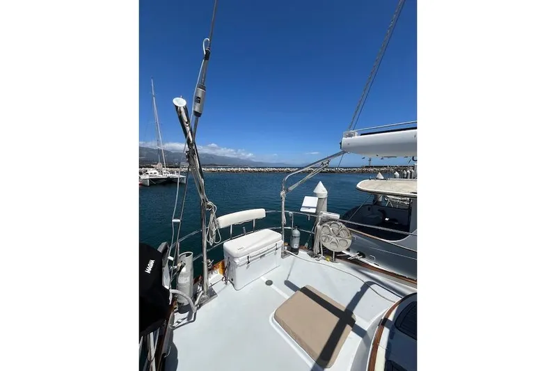 Wind Star Yacht Photos Pics Sailboat deck view of 1986 Liberty 49, docked in a sunny marina.